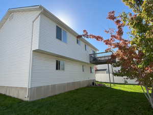 View of side of home with a yard