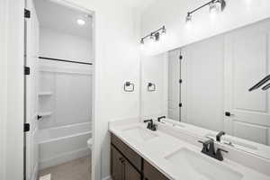 Full bathroom featuring vanity, toilet, and tub / shower combination