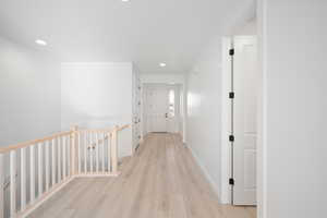 Hall with light hardwood / wood-style floors