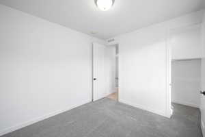 Unfurnished bedroom with carpet flooring and a closet