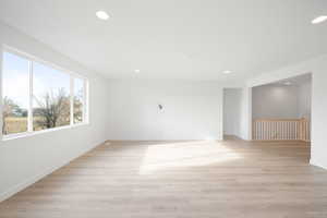 Empty room with light hardwood / wood-style flooring