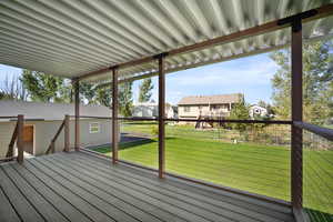 Wooden terrace featuring a lawn