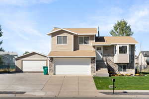 View of front of home featuring a front lawn and a garage