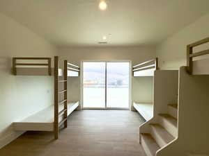 Unfurnished bedroom featuring access to outside and light hardwood / wood-style floors