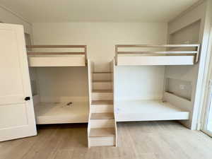 Unfurnished bedroom featuring light wood-type flooring