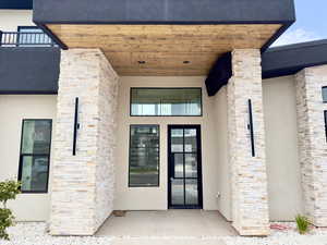 View of exterior entry with a balcony