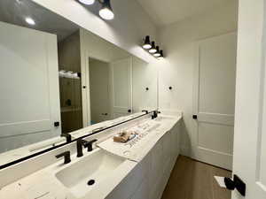 Bathroom featuring hardwood / wood-style flooring and vanity