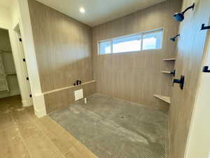 Bathroom featuring tile patterned flooring and tiled shower