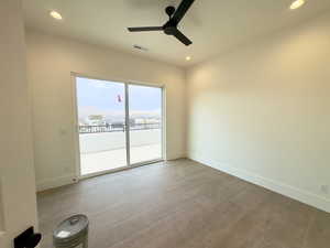 Empty room featuring light wood-type flooring and ceiling fan