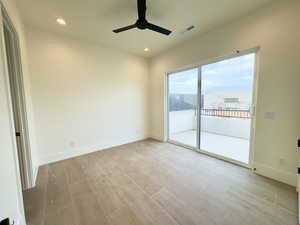 Spare room featuring ceiling fan, a mountain view, and light hardwood / wood-style floors