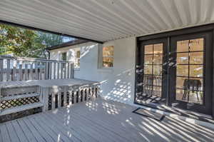 Wooden terrace featuring french doors