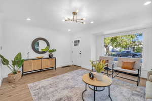 Living room featuring a notable chandelier and wood-type flooring