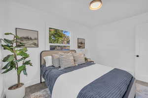 Carpeted bedroom with ornamental molding