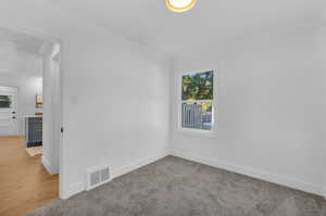 Carpeted empty room with crown molding