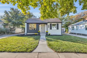 Bungalow-style house featuring a front yard