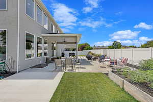 View of yard with ceiling fan and a patio area