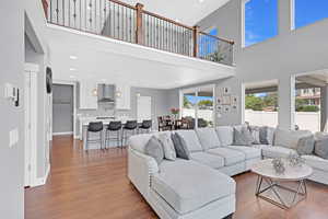 Living room featuring dark hardwood / wood-style floors and a high ceiling