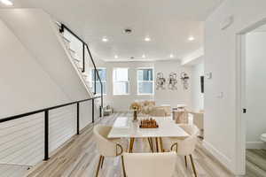 Dining area with light hardwood / wood-style floors