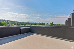 View of patio / terrace with a balcony and a mountain view