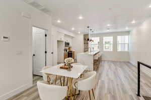 Dining area with light wood-type flooring