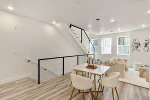 Dining space with light hardwood / wood-style flooring