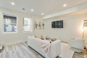 Living room with light hardwood / wood-style flooring