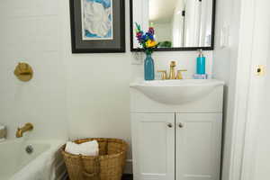 Bathroom featuring vanity and a tub to relax in