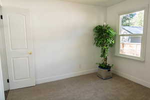 Spare room with plenty of natural light and light colored carpet