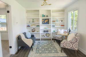 Sitting room featuring a notable chandelier and hardwood / wood-style flooring