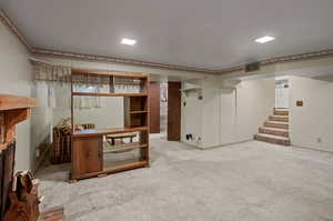 Basement with light colored carpet