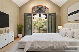 Bedroom featuring vaulted ceiling and light carpet