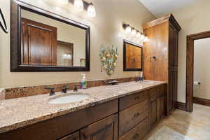 Bathroom with tile patterned flooring and vanity