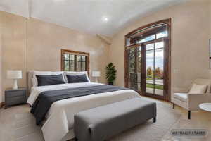 Carpeted bedroom with lofted ceiling, french doors, access to exterior, and multiple windows