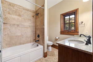 Full bathroom featuring vanity, toilet, and shower / bathtub combination with curtain