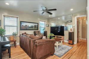 Living room featuring hardwood flooring and ceiling fan