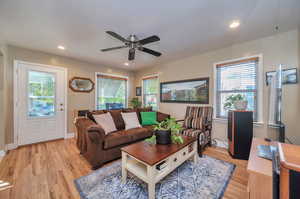 Living room with ceiling fan and hardwood floors