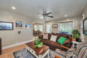 Living room featuring ceiling fan and hardwood floors