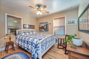 Bedroom featuring ceiling fan and Hardwood Flooring.