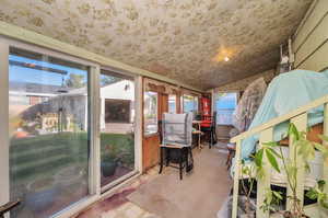 Unfurnished sunroom featuring vaulted ceiling