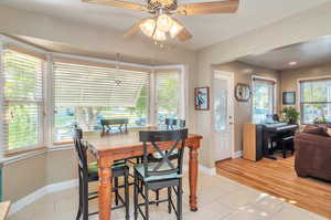 Dining space featuring ceiling fan and light tile patterned floors