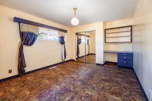 Bedroom 2 with built-in desk and closet