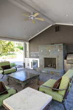 View of patio with ceiling fan, an outdoor fireplace, grilling area, and an outdoor kitchen