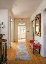 Entrance foyer with light hardwood / wood-floors. Entrance to rooms off entry are accessed with original pocket doors.