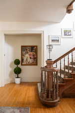 Hallway with hardwood / wood-style flooring