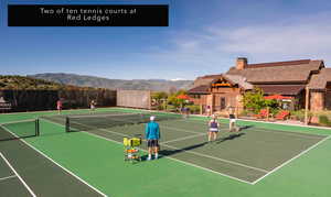 View of tennis court with a mountain view