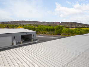 Wooden deck with a garage and a mountain view