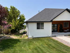 Back of property with a yard and a patio area