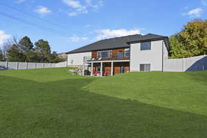 Back of house featuring a patio and a lawn