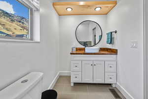 Bathroom with tile patterned floors, vanity, and toilet