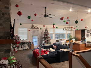 Living room featuring carpet floors, sink, a high ceiling, and ceiling fan